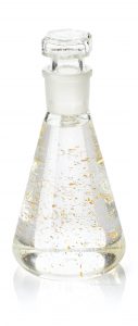 Erlenmeyer flask with serum and gold flakes